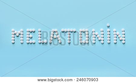 Melatonin, The Word Is Laid Out On A Blue Background Of Tablets. Tablets, Hormone And Excipients To 