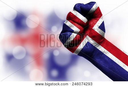 Flag Of Iceland Painted On Male Fist, Strength, Power, Concept Of Conflict. On A Blurred Background 
