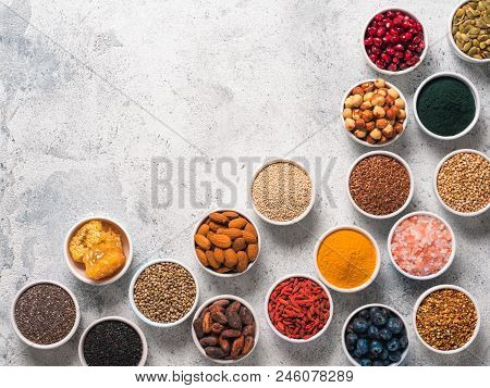 Various Superfoods In Smal Bowl Gray Concrete Background. Superfood As Chia, Spirulina, Raw Cocoa Be