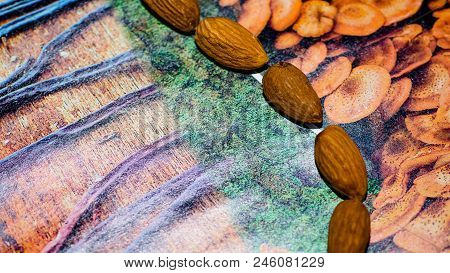 Raw Almonds Nuts On The Wooden Background