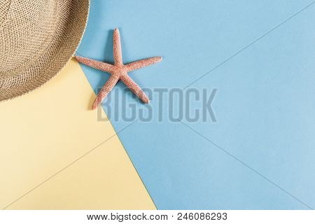 Part Of Straw Hat And Starfish On Pastel Blue-yellow Background With Copy Space.  Minimalis Vacation