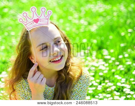 Girl On Dreamy Face Spend Leisure Outdoors. Child Posing With Cardboard Crown For Photo Session At M