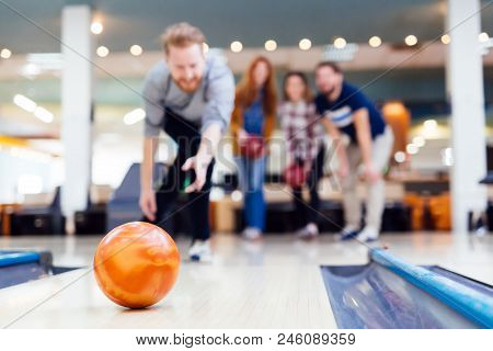 Friends Having Fun While Bowling And Speding Time Together