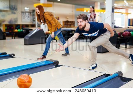 Friends Having Fun While Bowling And Speding Time Together