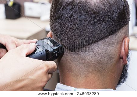 Men's Hair Styling And Grooming With The Help Of Scissors Machine And Hair Clippers In The Hair Salo