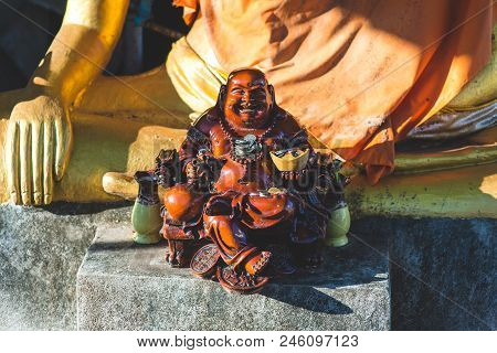 Small Statue Of Budai With Money On Koh Samui, Thailand