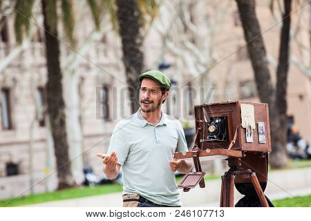 Barcelona - March, 2018: Young Male Photographer Taking Pictures Using A Vintage Wooden Camera At Th