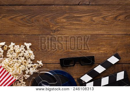 Cinema Background, Top View. Clapperboard, Popcorn, Soda And 3d Glasses On Wooden Table, Copy Space.