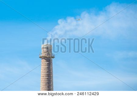 Smoke From Pipes In The Plant, Polluting The Environment. Dirty Air In The Sky.