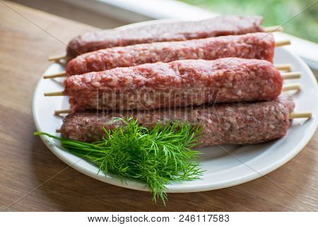 Raw Lulya Kebab From Meat On A White Plate.
