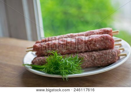 Raw Lulya Kebab From Meat On A White Plate.