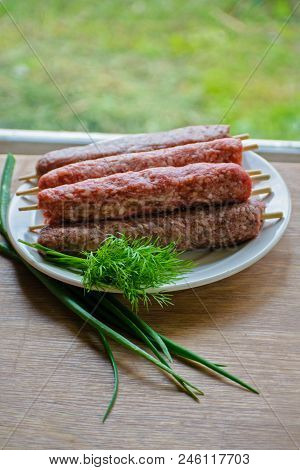 Raw Lulya Kebab From Meat On A White Plate.