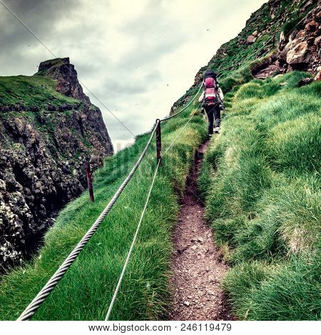 woman hiking on mykines faroe islands