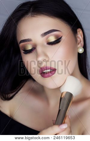 Beautiful Brunette With Makeup Brush