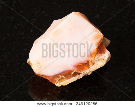 Macro Shooting Of Natural Mineral - Raw Precious Opal And Fire Opal Gem On Black Granite From Ural M