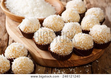 Delicious Brazilian Sweets Beijinhos De Coco With Condensed Milk And Coconut Close-up. Horizontal