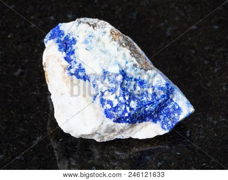 Macro Shooting Of Natural Mineral - Rough Lazurite (lapis Lazuli) Gemstone On Black Granite From Ura