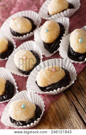 Brazilian Dessert Sweets Olho De Sogra From Condensed Milk, Prunes And Coconut Close-up. Vertical