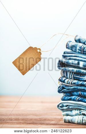 Sale, Discount, Black Friday Concept With Tag , Blue Jeans On A Light Background. Close Up.