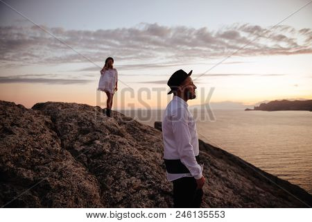 Romantic Summer Love Story On A Sunset In Mountains. Young Girl And Boy In Love.