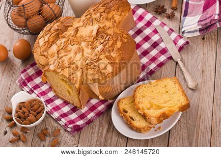 Easter Dove Bread Colomba Pasquale On Wooden Table.
