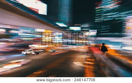 Abstract Blurred View Of People And Traffic Crossing A Busy Intersection In Shibuya, Tokyo, Japan