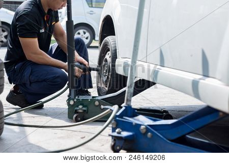 Mechanic Is Changing Car Wheel At Tyre Shop.