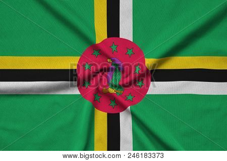 Dominica Flag  Is Depicted On A Sports Cloth Fabric With Many Folds. Sport Team Waving Banner