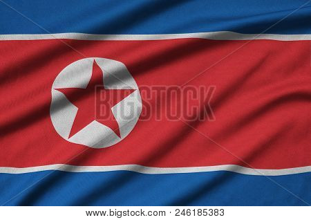 North Korea Flag  Is Depicted On A Sports Cloth Fabric With Many Folds. Sport Team Waving Banner
