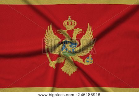 Montenegro Flag  Is Depicted On A Sports Cloth Fabric With Many Folds. Sport Team Waving Banner