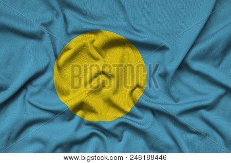 Palau Flag  Is Depicted On A Sports Cloth Fabric With Many Folds. Sport Team Waving Banner
