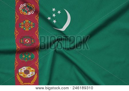 Turkmenistan Flag  Is Depicted On A Sports Cloth Fabric With Many Folds. Sport Team Waving Banner