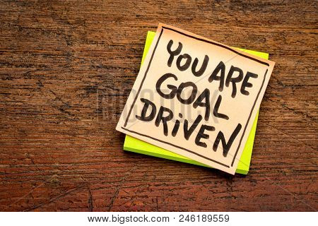 You are goal driven - positive affirmation - handwriting on a sticky note agianst rustic wood