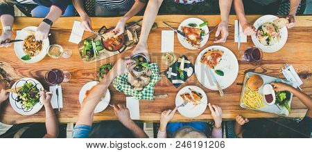 Family Or Friends Summer Party Or Outdoor Dinner. Flat-lay Of Group Of People At Big Table In Cafe E