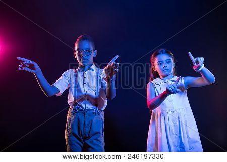 Being Smart. Happy Cute Boy And A Girl Standing Next To Each Other And Pressing Imaginary Buttons