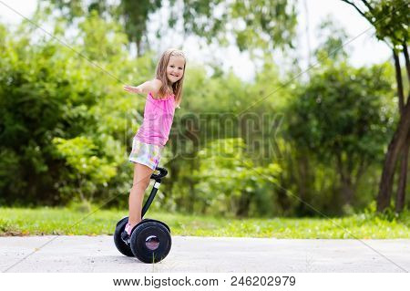 Child On Hover Board. Kids Riding Scooter In Summer Park. Balance Board For Children. Electric Self 