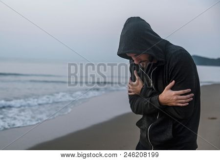 Caucasian man walking alone at the beach