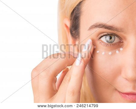 Eye Cream Treatment. Close Up Of Green Eye Beautiful Woman Applying Eye Cream. Anti-aging And Wrinkl