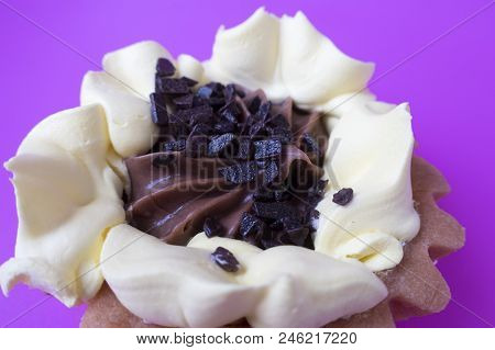 Cake Basket Of Short Pastry Cream And Chocolate Close-up On Purple Background