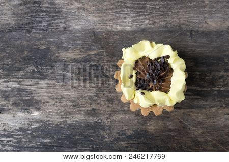 Beautiful Cake Basket With Cream And Chocolate On A Wooden Background In Rustic Style, Copy Space