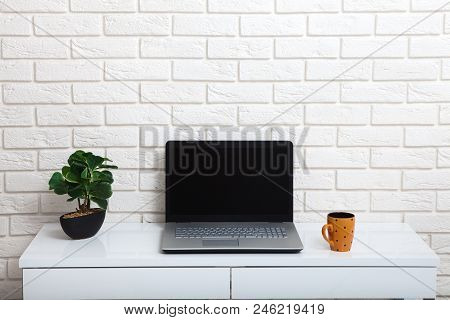 White Table Near The White Wall. Empty Workplace In The Room. White Background.mock Up.