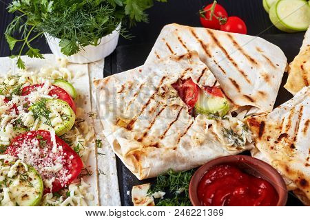 Flatbread Wraps Stuffed With Tomato And Zucchini Slices, Greens And Grated Mozzarella Cheese - Delic