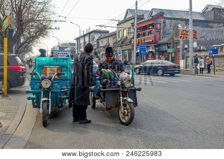 Beijing, China - March 12, 2016: People Are Driving Through The Streets With Bicycles, Scooters And 