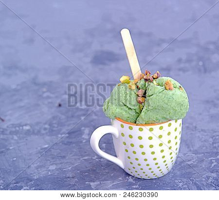 Frozen Yogurt Or Natural Green Ice Cream In Balls With Pistachios.