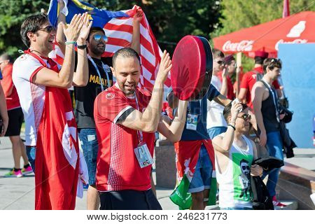 Football Fans Of The National Team Of Tunisia With National Flags And Attributes