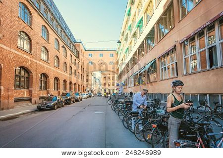 Stockholm, Sweden - Jun 14, 2018: Woman In Helmen On Bicycle Parking Of Historical Swedish City On J