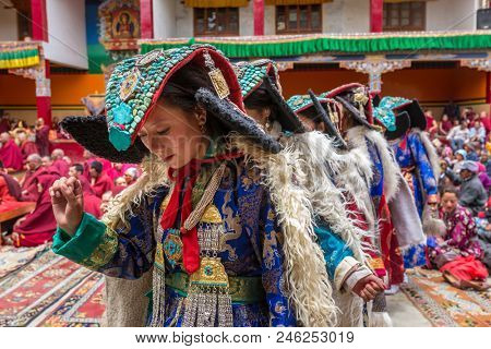 Lamayuru, India - June 19, 2017: Unidentified Zanskari women wearing ethnic costumes and traditional Ladakhi headdress with turquoise stones called Perakh Perak dancing during Buddhist festival