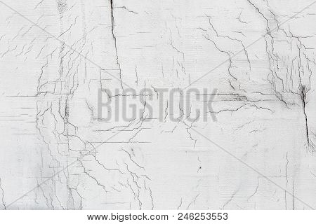 Texture Of White Dirty Cracked Wall. Small Straight Cracks. Direct Fracture On Painted Surface. Cell