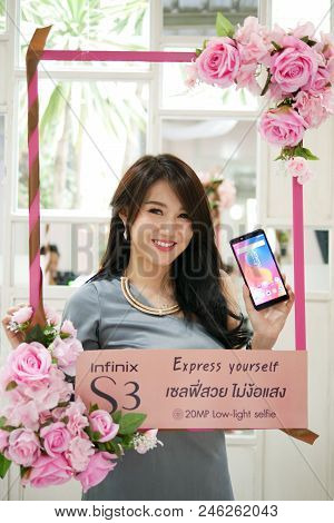 Bangkok, Thailand - February 9, 2018: Pretty Girl Is Showing Infinix S3, The Latest Android Smartpho