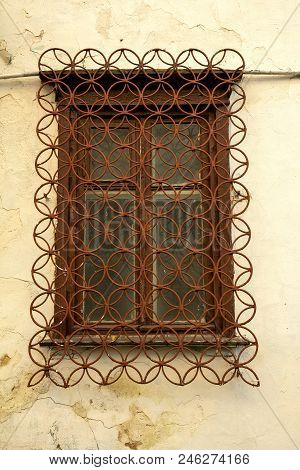 Old Window Frame With Metal Grating. Window In An Old House For Design.